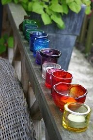 there are many glasses lined up on the bench