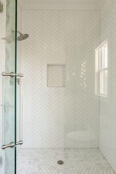 Bathroom Shower Herringbone Tile, Subway Tile Shower Herringbone, White Herringbone Backsplash Bathroom, Coastal Shower Floor Tile, Herringbone Backsplash Bathroom Shower Walls, Shower Floor Tile Ideas Coastal, White Chevron Shower Tile, Chevron Accent Tile Shower Wall, Herring Bone Shower Wall