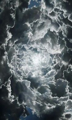 the sky is full of clouds and bright sun shining through it's dark clouds