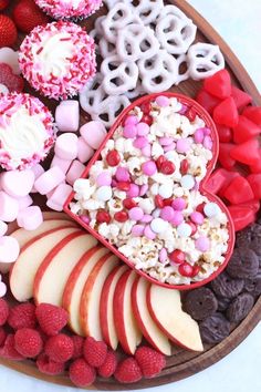 a heart shaped tray filled with valentine's treats