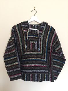 A Vintage Baja Hoodie, Mexican Woven Jacket from the 1990s.  Brand: No Tags for Brand. One tag only that says M for Medium. (Despite the measurements below, it appears to be smaller than these measurements. Best for Adult Small or Youth Medium-Large). Great for Camping, Surfing on the Beach or Festival Season. 50% Polyester 40% Acrylic 10% Cotton  Made in Mexico. Despite the measurements below, it appears to be smaller than these measurements. Best for Adult Small or Youth Medium-Large. ✂ - - - - - M E A S U R E M E N T S:  taken lying flat:  Bust/Chest from Underarm to Underarm: 19 inches (38 inches doubled) Length from Shoulder to Bottom Hem:  21.5 inches From Shoulder Seam to Shoulder Seam: 21.5 inches Waist Area: 18 inches (36 inches doubled) Sleeve Length (from Underarm to Cuff): 17 i Multicolor Winter Sweatshirt With Kangaroo Pocket, Winter Multicolor Sweatshirt With Adjustable Hood, 90s Style Long Sleeve Hooded Jacket For Fall, 90s Long Sleeve Winter Hoodie, Retro Hoodie With Double-lined Hood, Retro Hoodie With Double-lined Hood And Long Sleeves, Multicolor Hooded Jacket With Double-lined Hood, Retro Long Sleeve Hoodie With Double-lined Hood, 90s Style Winter Hoodie With Double-lined Hood