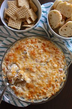 two bowls of dip and crackers on a table