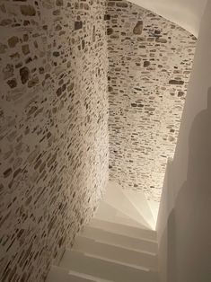 an empty room with stone walls and stairs