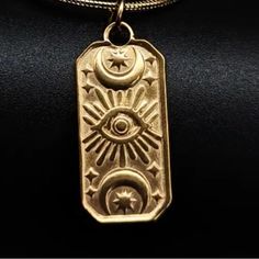 “Symmetry In The Stars” Evil Eye Sunburst Sunrays Eye Of Ra Crescent Moon Mystical Tarot Egyptian Rectangular Sky Totem Celestial Cosmos Astrology Astronomy Universe Galaxy 18k Gold Double Sided Necklace. A Central Image Of An Evil Eye With Radiating Sunbeams/Eye Of Ra Is Sandwiched By Symmetrical Horizontal Crescent Moons With Little Stars Nestled Inside. Two Stars Frame The Moons On Either Side. Double-Sided! On A Cable Chain. 18k Gold. Hypoallergenic. Lead & Nickel Free. Unisex Women Or Men. Jeweled Necklace, Eye Of Ra, 18k Gold Necklace, Evil Eye Charm, Gold Design, Evil Eye, Matching Earrings, Womens Jewelry Necklace, 18k Gold