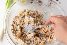 a person is mixing food in a bowl