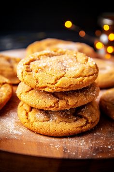 a pile of cookies sitting on top of a wooden cutting board