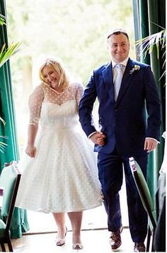 a bride and groom walking down the aisle