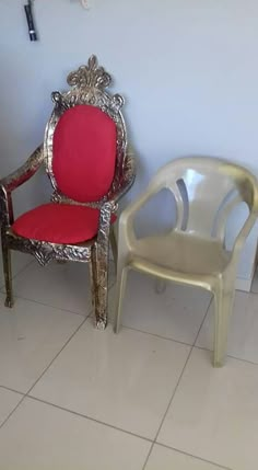 two chairs sitting next to each other in a room with tile flooring and white walls