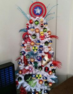 a white christmas tree decorated with avengers ornaments