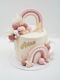 a white cake with pink and gold decorations