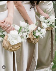 two bridesmaids holding bouquets with white flowers