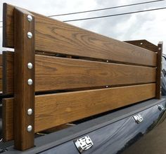 the back end of a pickup truck with wooden slats