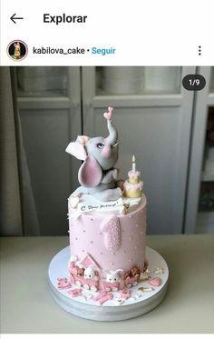 a pink and white cake with an elephant on top