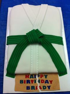 a birthday cake with a green ribbon on it