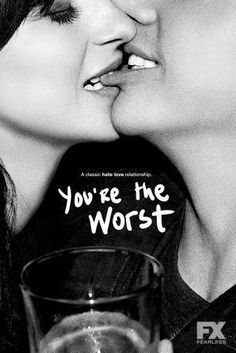 two women kissing each other while holding a wine glass with the words you're the worst written on it