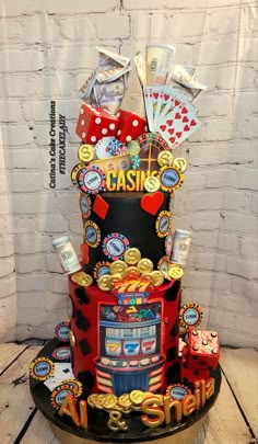 a casino themed cake with lots of gambling chips and cards on it's top