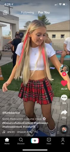 a girl with long blonde hair wearing a red and black plaid skirt while standing on a skateboard