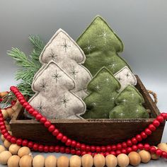 three christmas trees in a wooden box with beads