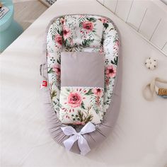 a baby bassinet with pink flowers on it