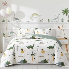 a bed room with a neatly made bed and dinosaur wall decals