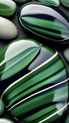 some green and white rocks and one has a cell phone in it's hand