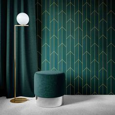 a green and white room with a gold floor lamp next to a round foot stool