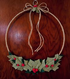 an ornament with holly leaves and red berries