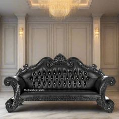 an ornate black leather couch with chandelier in the background and marble flooring