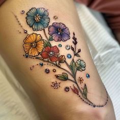 a woman's leg with colorful flowers on it