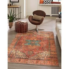 an orange and blue rug with a brown chair