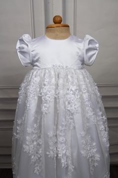 Christening gown for baby girls Gown length: 31 inches Color: white Embroidery: Beads and 3d flowers Fabric: Lace and Satin Underlay - 2 layers, satin and cotton Weight - Lightweight Sleeve - Puff sleeves Features - Floral accents on the waistline, zip closure at the back Please note: Dry clean only. Caremour promises - 1) Stress free shipping guarantee - Free expedited international shipping - Offer applicable Worldwide. Typical shipping time: 3-7 days 2) No surprise guarantee - Rest assured th White Princess Dress With Floral Applique For First Communion, Elegant Lace First Communion Dress With Floral Applique, White Floral Applique First Communion Dress, Lace Princess Dress With Floral Applique For Baptism, White Lace First Communion Dress With Floral Applique, Elegant Floral Applique Dress For Baptism, Elegant Princess Dress With Floral Applique For First Communion, Elegant First Communion Princess Dress With Floral Applique, Fitted Floral Embroidery Baptism Dresses