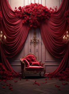 a red chair sitting in front of a curtain with roses on it and chandelier