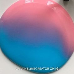 a pink and blue plate sitting on top of a table