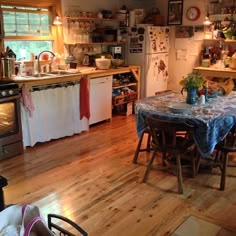 a kitchen filled with lots of counter space and furniture next to a stove top oven