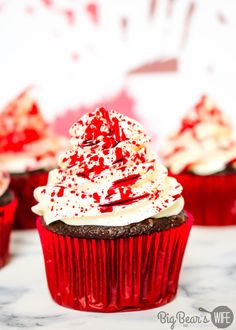 blood splatter cupcakes with white frosting and red sprinkles