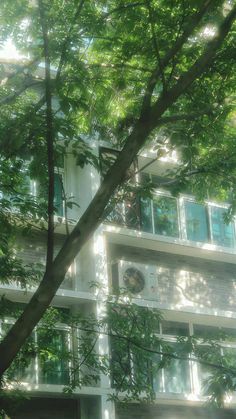 an apartment building is seen through the trees