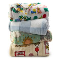 four baby blankets stacked on top of each other