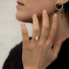 a close up of a person wearing a ring