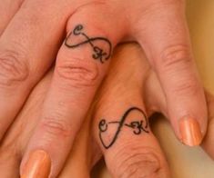 two people with matching tattoos on their fingers