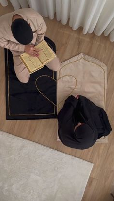 a person sitting on the floor reading a book