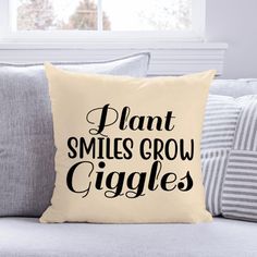 a pillow that says plant smiles grow giggles