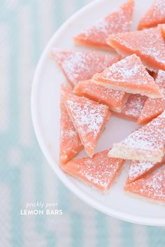 powdered sugar coated desserts on a white plate