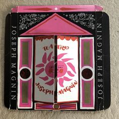 a pink and black box with an open door that says tea is the main ingredient