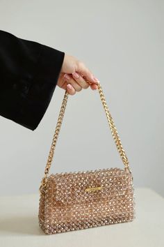 Crystal beaded bags are popular choices for formal occasions, evening events, or any time when a touch of glamour is desired. They can add a statement-making element to an outfit and are often chosen to complement elegant dresses or evening gowns. The beaded texture of the bag not only adds visual interest but also provides a tactile and luxurious feel. Whether you're treating yourself or searching for the perfect gift for a fashion-forward friend, this crystal beaded bag is sure to impress. Elevate your style with this eye-catching accessory and turn heads wherever you go. Glamorous Handheld Bag With Chain Strap, Party Shoulder Bag With Rhinestones, Rectangular, Glamorous Handheld Shoulder Bag With Chain Strap, Rhinestone Clutch Shoulder Bag For Party, Party Shoulder Box Bag With Chain Strap, Trendy Gold Pouch Evening Bag, Glamorous Rectangular Box Bag For Party, Glamorous Sequined Bags For Events, Glamorous Event Bags With Sequins