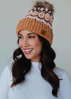 Look cute and stay warm all winter long in this super soft chenille feel hat! Our new collection of pom hats is one you won't want to miss out on! This knit winter hat features fleece lining and a faux fur pom accent.  Camel and multicolored patterned knit pom hat Natural faux fur pom accent Fleece lined Crown patch on the left side One size Designed in the U.S.A. Produced in China. 100% Polyester Pom Hats, Knit Winter Hat, Knitted Hats Kids, Knit Hat For Men, Knit Jewelry, Dangle Necklaces, Animal Books, Winter Hats For Women, Faux Fur Pom Pom