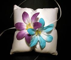 three different pillows with flowers on them