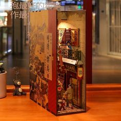 an open box sitting on top of a wooden table next to a potted plant