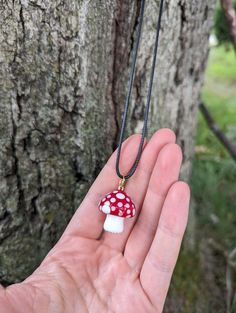 Elevate your witchy accessory game with our stunning red glass mushroom necklace. Handcrafted with love, this piece is both whimsical and nature-inspired.  Add a pop of enchanting color to your look and embrace the elegance of this unique necklace! Whether for a special occasion or everyday wear, this cute little glass mushroom necklace is sure to garner compliments and spark cottagecore conversations. Shop now and indulge in a touch of woodland charm that effortlessly complements your style. Comes on a 20 inch chain. Please note that all our shipping prices DO include the price for us to use third-party insurance for your packages. That extra $.80-$1.00 that you pay goes towards double ensuring your precious item(s) so that if the mail service (heaven forbid) drops the ball, we will have Bohemian Adjustable Necklace With Mushroom Design, Whimsical Mushroom Design Necklace For Gift, Red Mushroom Necklace, Crystal Mushroom Necklace, Glass Mushroom Necklace, Cottagecore Gifts, Glass Mushrooms, Free Items, Red Glass