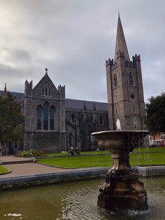 a fountain in front of an old church