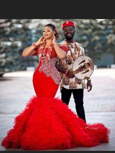 a man and woman dressed in red posing for the camera